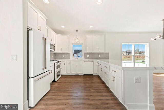 kitchen featuring white appliances, white cabinetry, and dark hardwood / wood-style flooring