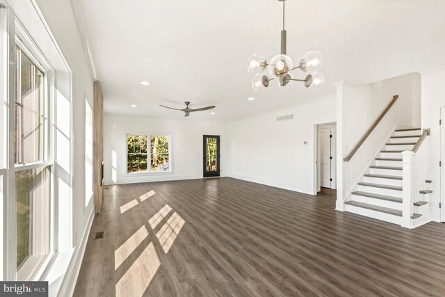 unfurnished living room featuring dark hardwood / wood-style flooring, crown molding, and ceiling fan with notable chandelier