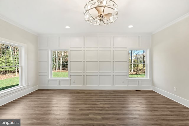 unfurnished room featuring dark hardwood / wood-style floors, a healthy amount of sunlight, and a chandelier