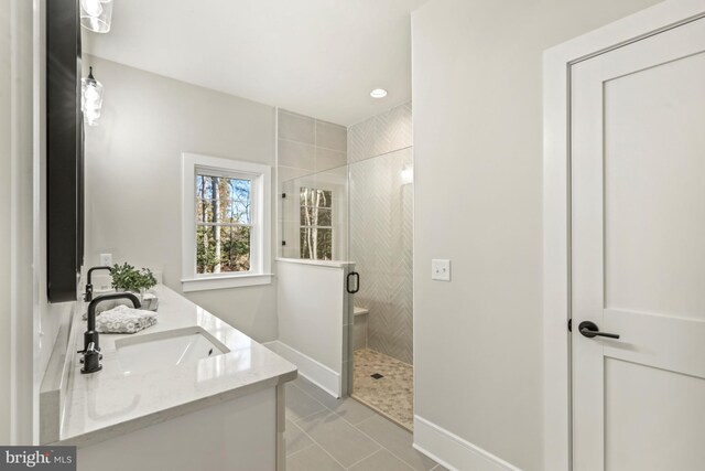 bathroom with double vanity, tile flooring, and an enclosed shower