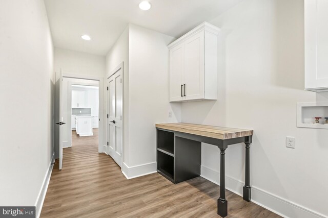 hallway with light hardwood / wood-style flooring