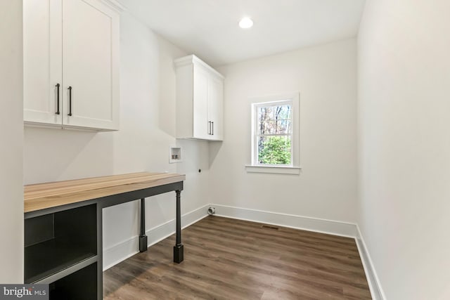 laundry area with dark hardwood / wood-style flooring, electric dryer hookup, cabinets, and hookup for a washing machine