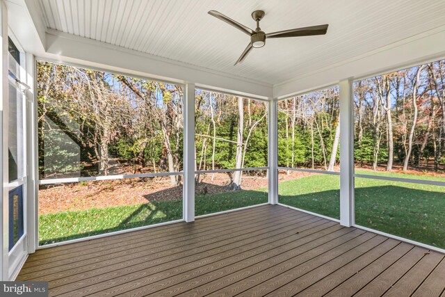 unfurnished sunroom featuring ceiling fan