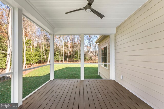 unfurnished sunroom featuring ceiling fan