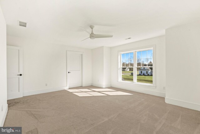 carpeted empty room featuring ceiling fan