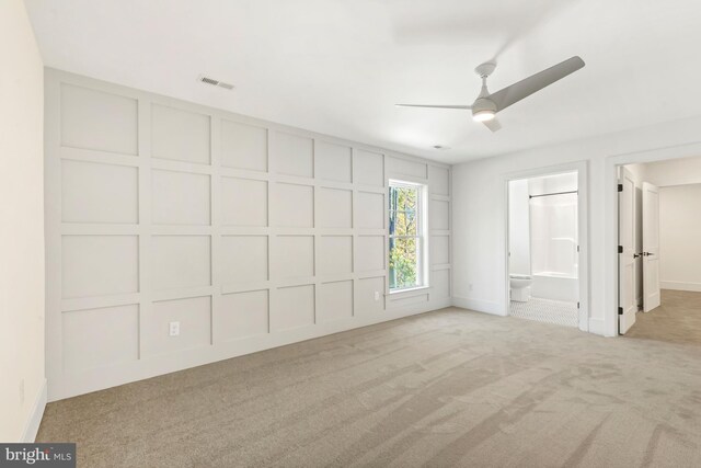 empty room with light colored carpet and ceiling fan