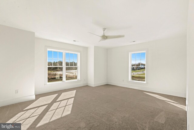 unfurnished room featuring light carpet and ceiling fan