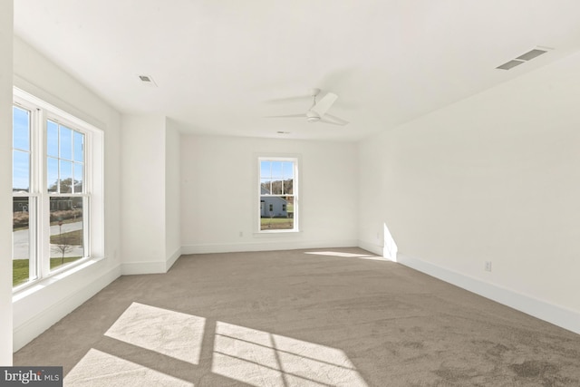 carpeted empty room featuring ceiling fan