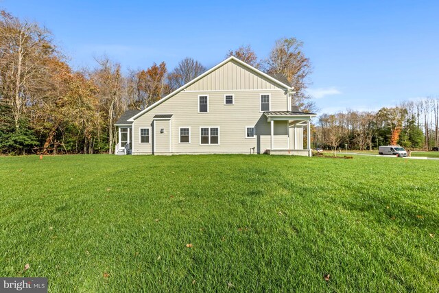 back of house with a lawn