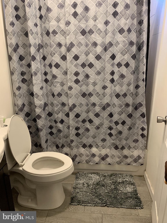 bathroom featuring vanity, toilet, and tile floors