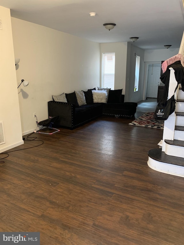 unfurnished living room with dark hardwood / wood-style floors