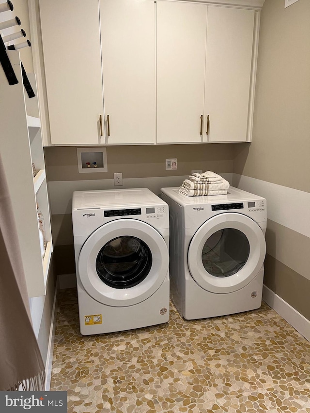 laundry room with washing machine and dryer, cabinets, hookup for a washing machine, and light tile floors