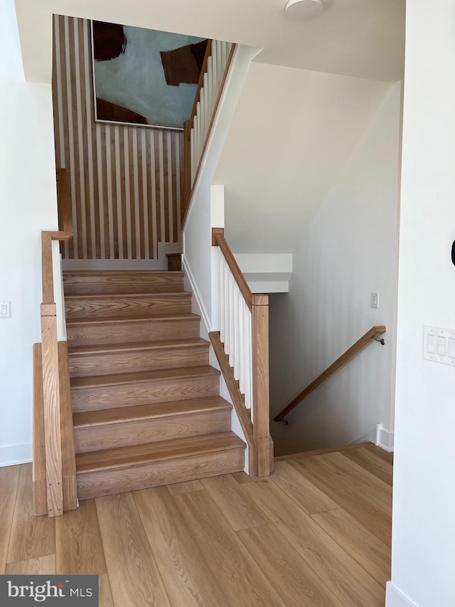 staircase with light wood-type flooring