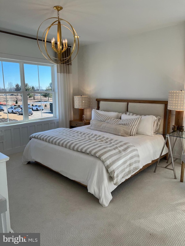 carpeted bedroom featuring a notable chandelier