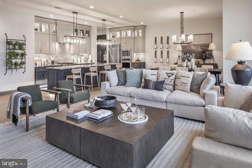 living room with sink and an inviting chandelier