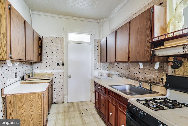 kitchen featuring light tile flooring, sink, backsplash, and white gas stove