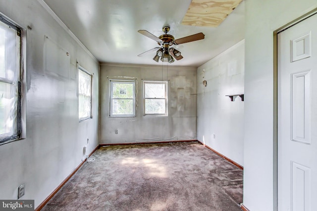 carpeted spare room featuring ceiling fan