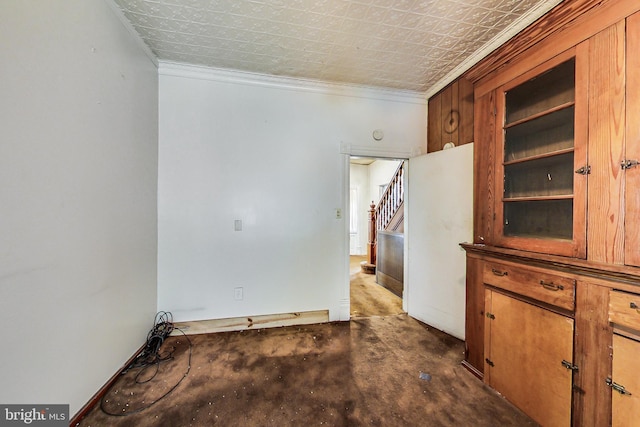 empty room with built in features and crown molding