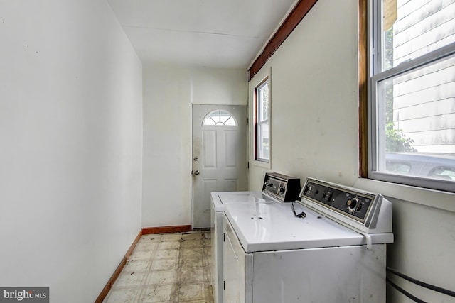 laundry area featuring light tile floors and separate washer and dryer