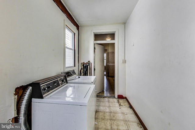 laundry room with light tile floors and washing machine and dryer