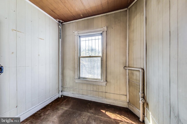 spare room with wooden walls and wood ceiling