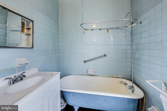 bathroom featuring tile walls and vanity