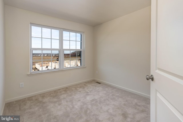 spare room with light colored carpet