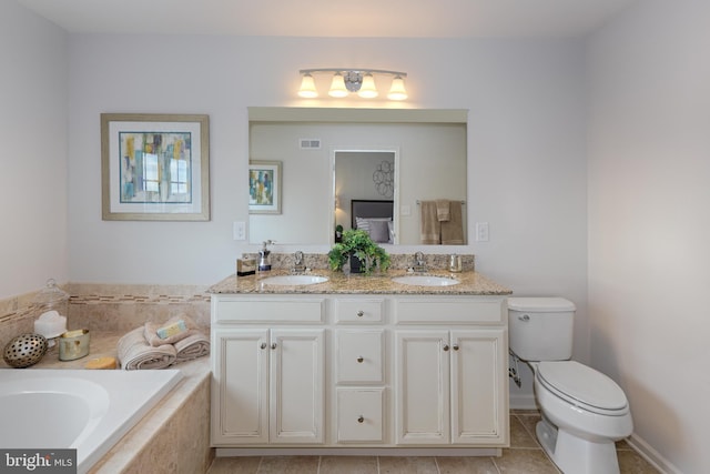 bathroom with a relaxing tiled bath, tile floors, toilet, and dual bowl vanity