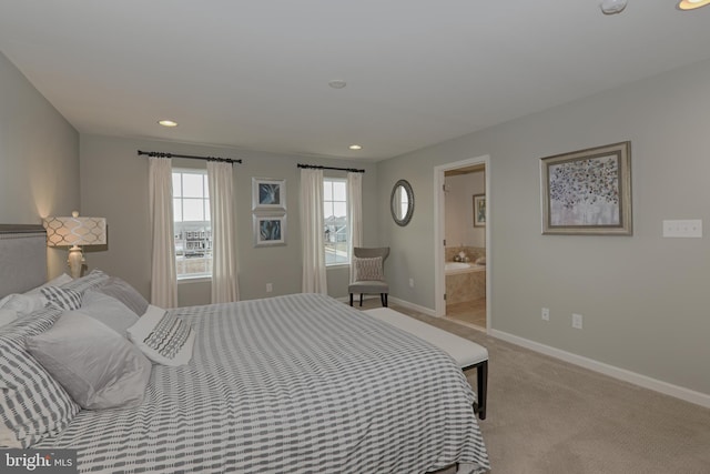 bedroom with light colored carpet and ensuite bathroom