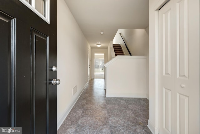 hallway featuring light tile floors