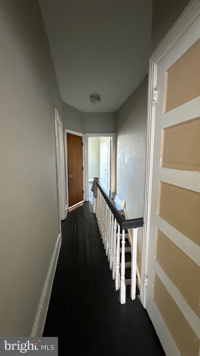 corridor featuring dark wood-type flooring