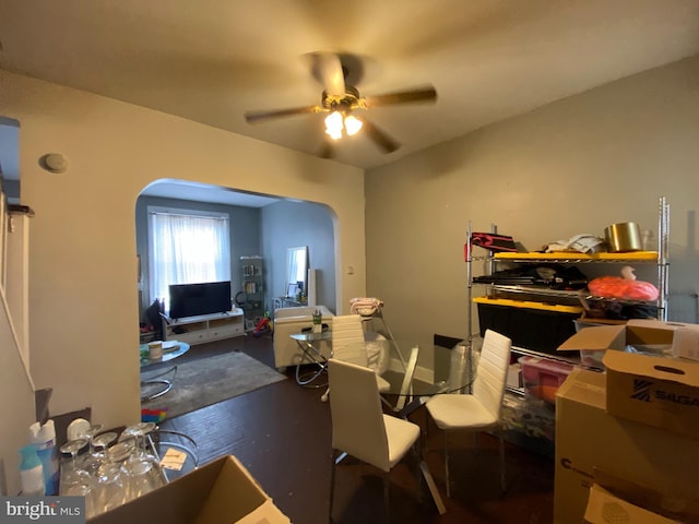 dining space with dark hardwood / wood-style flooring and ceiling fan