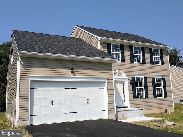 colonial-style house featuring a garage