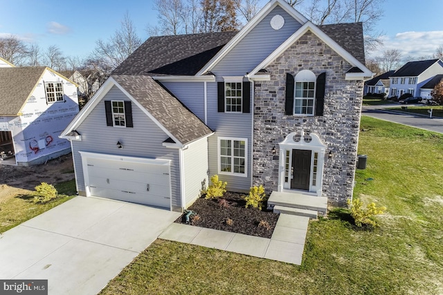 view of front of property featuring a front yard and a garage