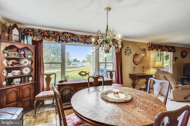 dining area with a healthy amount of sunlight, ornamental molding, and an inviting chandelier