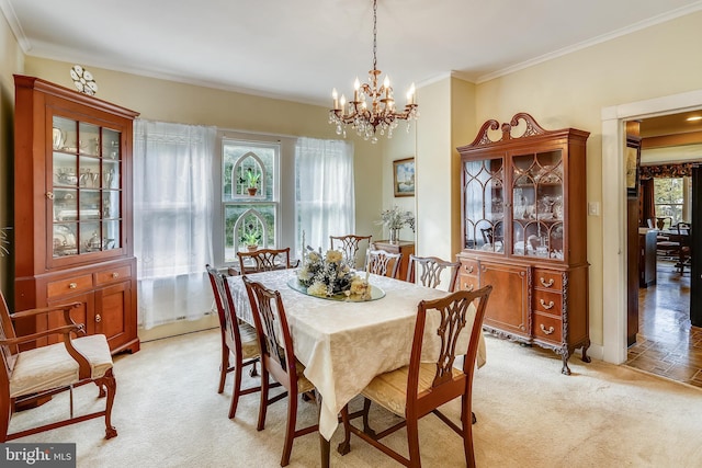 dining space with a chandelier, a healthy amount of sunlight, light tile flooring, and crown molding