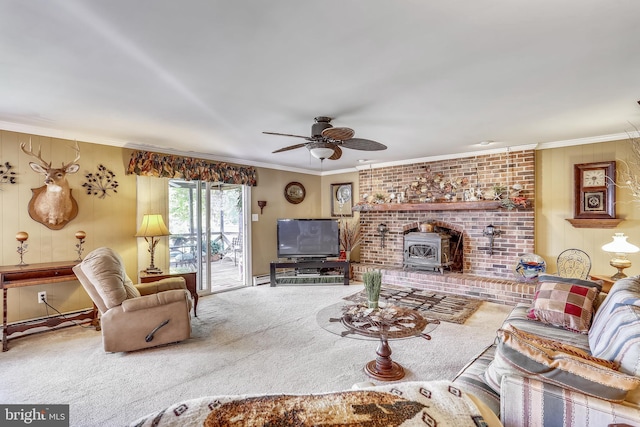 living room with a fireplace, crown molding, carpet flooring, and ceiling fan