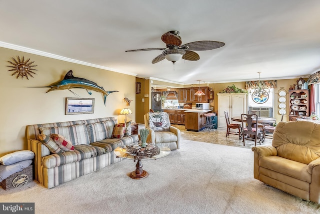 living room with light carpet, crown molding, and ceiling fan with notable chandelier