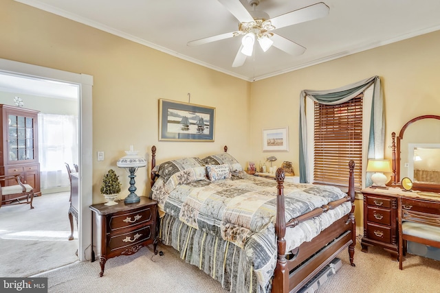 carpeted bedroom with ceiling fan and ornamental molding