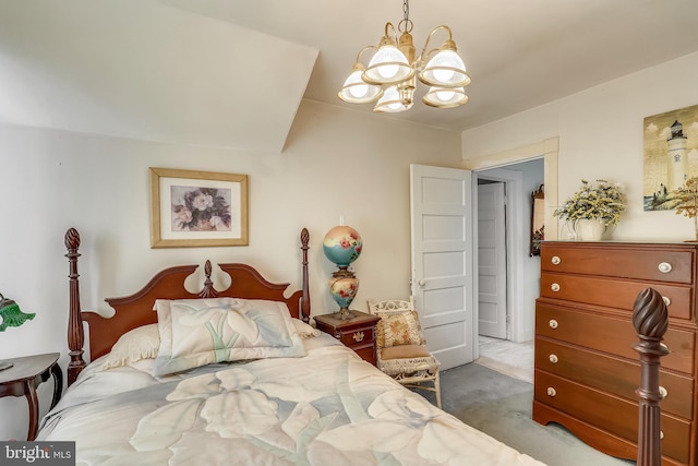 carpeted bedroom featuring an inviting chandelier