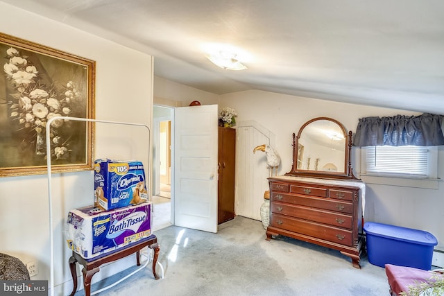 bedroom with lofted ceiling and light carpet