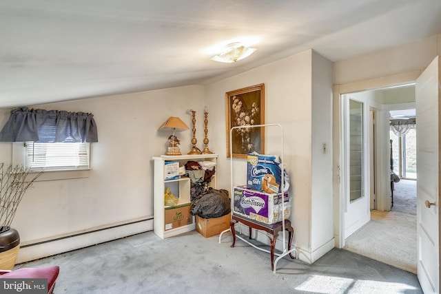 interior space with light carpet, a healthy amount of sunlight, and baseboard heating