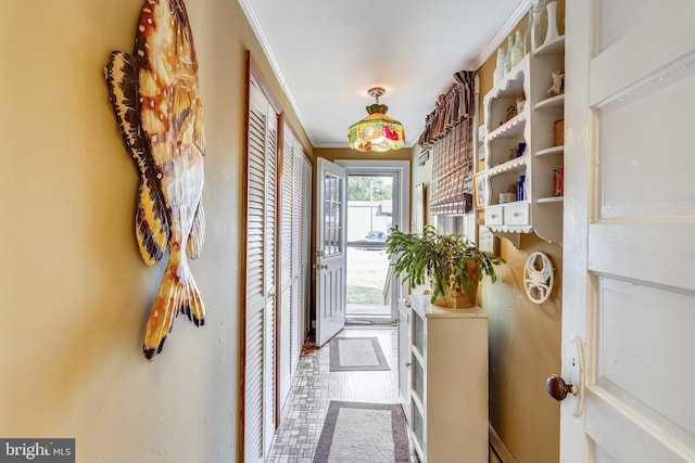 entryway featuring crown molding and tile floors