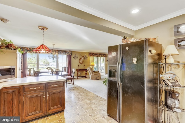 kitchen with decorative light fixtures, crown molding, refrigerator with ice dispenser, and light colored carpet