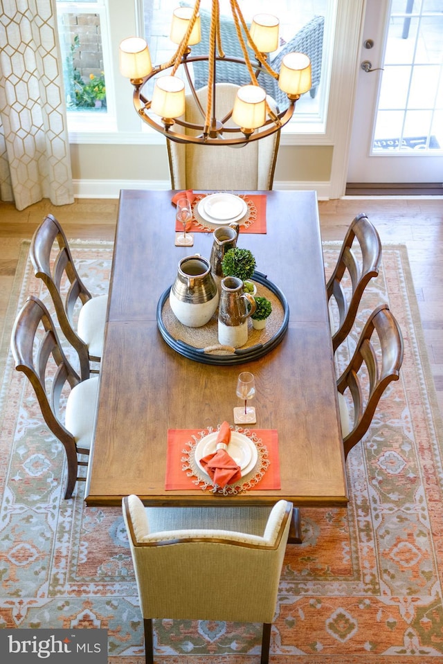 dining area featuring a notable chandelier and light hardwood / wood-style floors