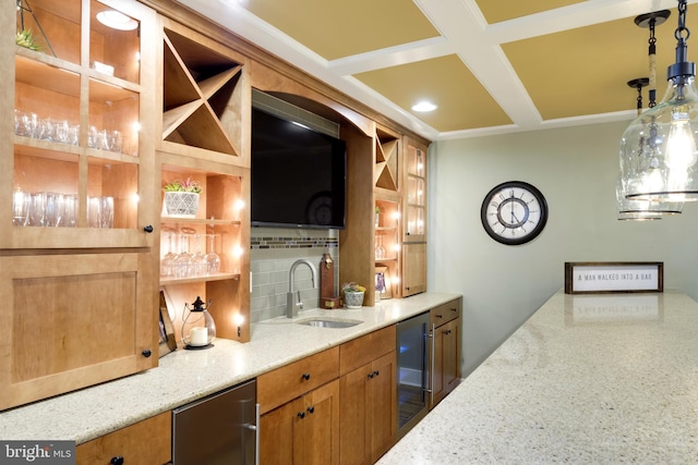 bar featuring light stone counters, hanging light fixtures, beverage cooler, and sink