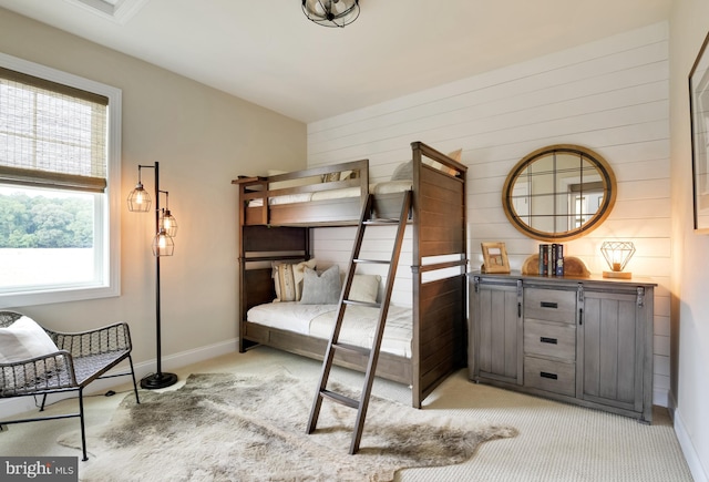 bedroom with light carpet and multiple windows