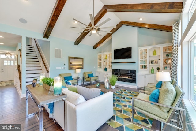 living room featuring plenty of natural light, dark hardwood / wood-style flooring, ceiling fan, and lofted ceiling with beams