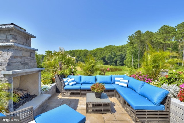 view of patio featuring an outdoor living space with a fireplace