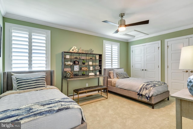 carpeted bedroom with ceiling fan and crown molding